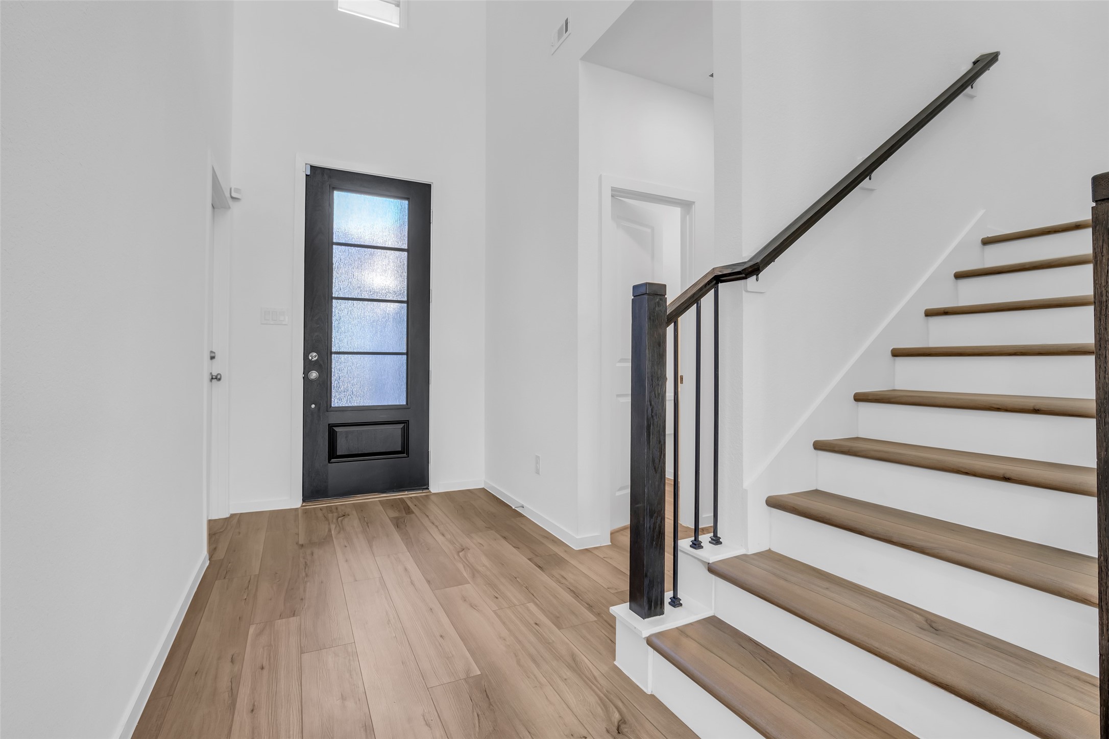 8619 Jade Hl Drive Rosharon, TX 77583 - Photo 13 of 50 Main Entry & Interior Next Gen Access: A dramatic, light-filled foyer with soaring ceilings, modern railing, and immediate interior access to the Next Gen suite, allowing connection without stepping outside.