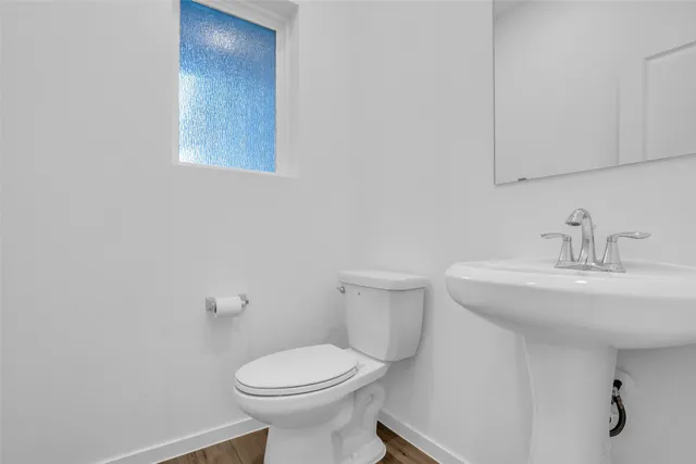 a bathroom with a sink toilet and mirror