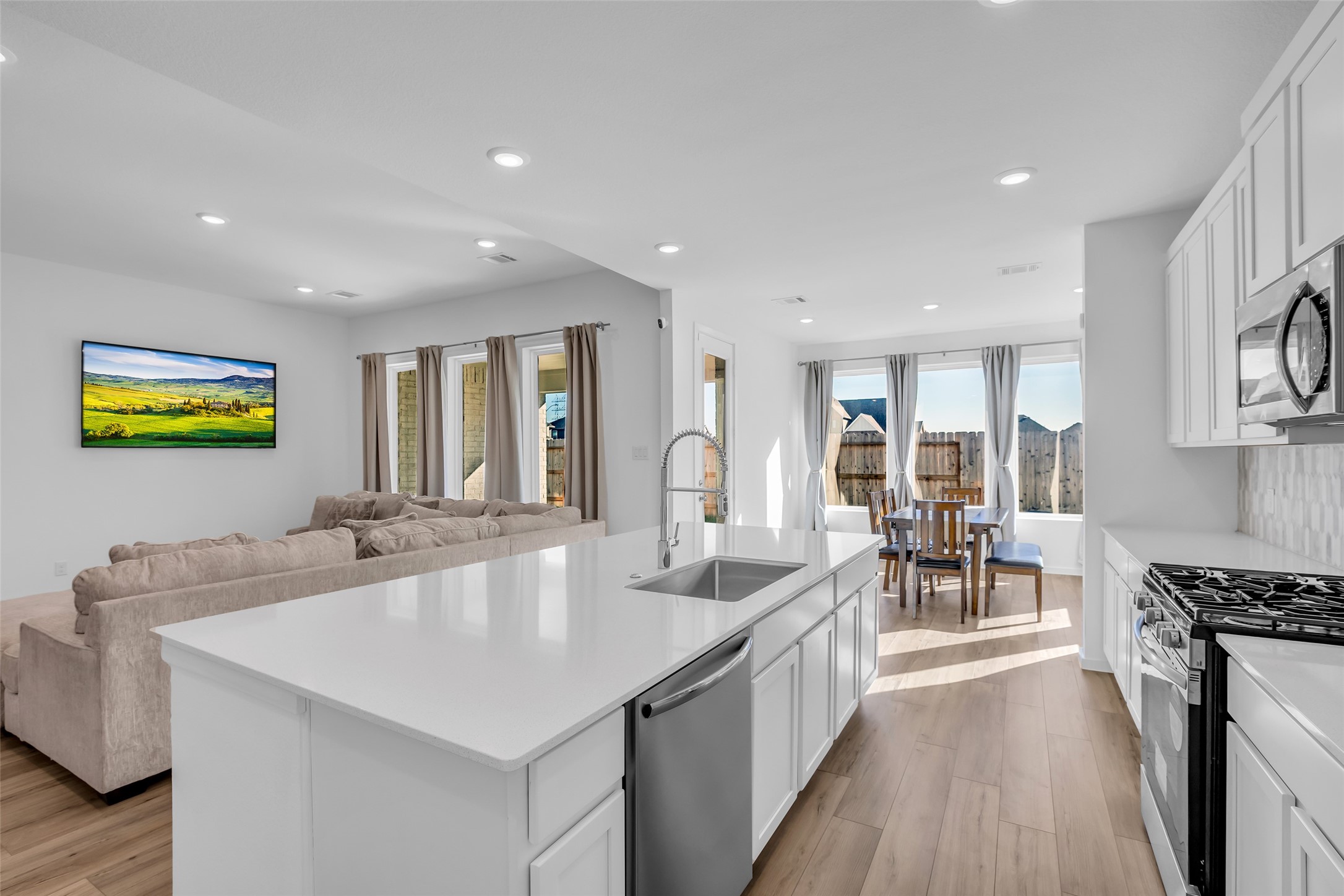 8619 Jade Hl Drive Rosharon, TX 77583 - Photo 21 of 50 Kitchen Anchored by the Island: A spacious quartz island becomes the heart of the home, offering room to prep, gather, and connect. Open flow to the living and dining areas keeps everything effortless and inviting.