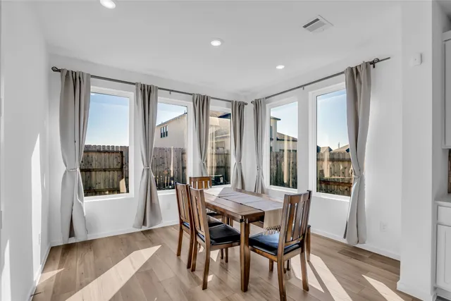 a view of a dining room with furniture and window