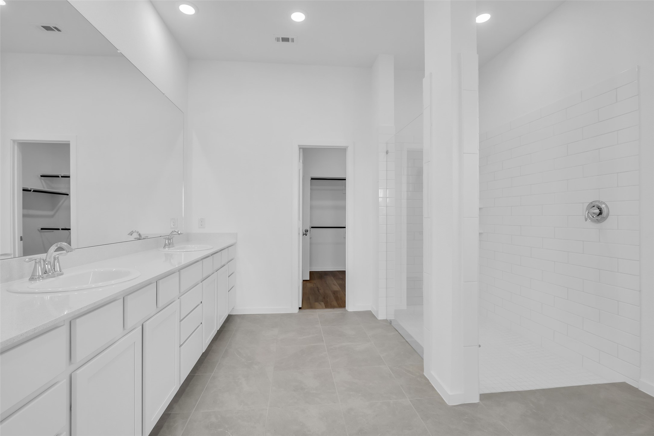 8619 Jade Hl Drive Rosharon, TX 77583 - Photo 31 of 50 Primary Bathroom: Spacious layout featuring an extended dual-sink vanity, oversized walk-in shower, and a seamless view toward the walk-in closet for an efficient, well-connected suite design.
