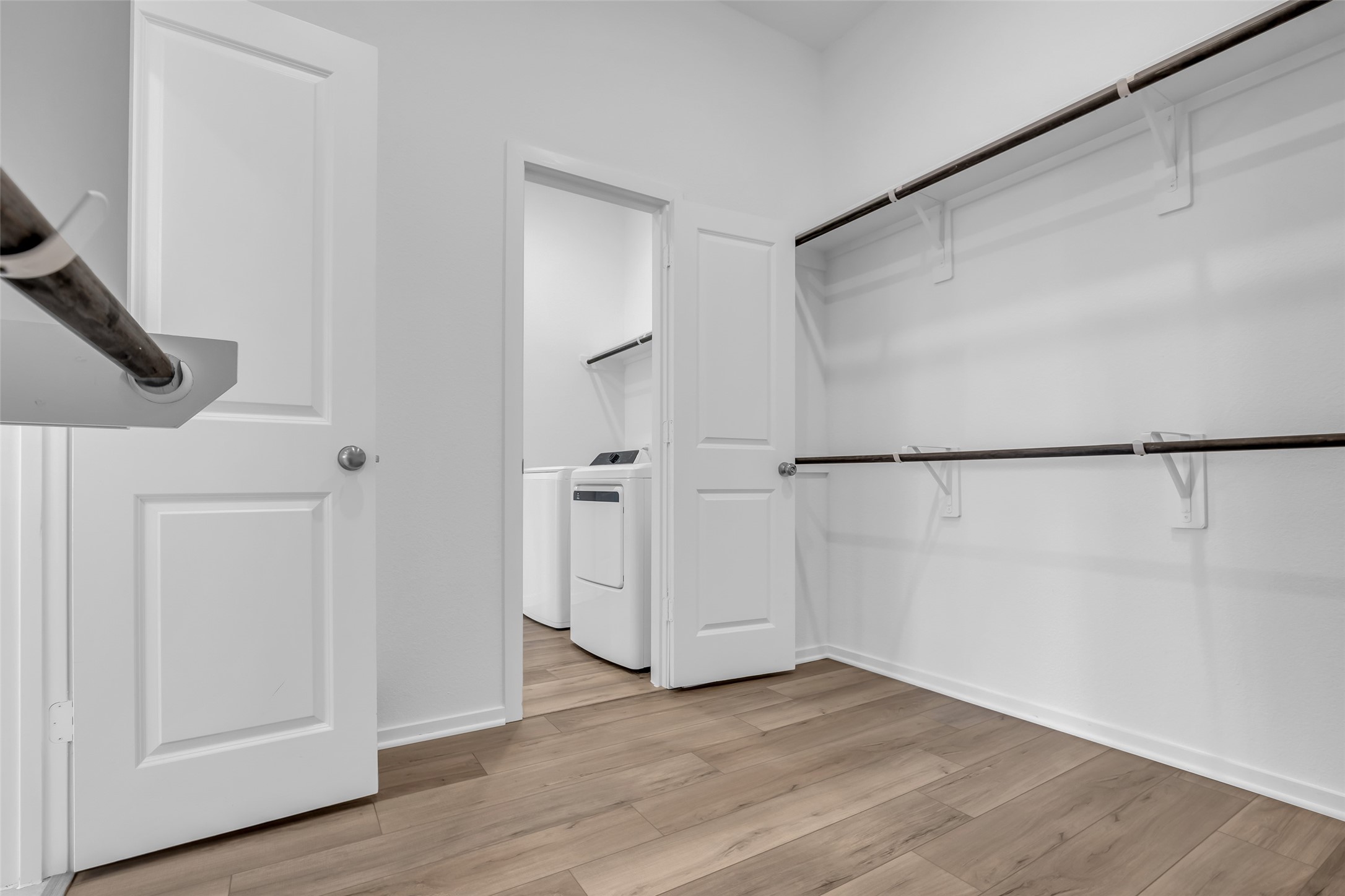 8619 Jade Hl Drive Rosharon, TX 77583 - Photo 32 of 50 Walk-In Closet: Generously sized walk-in closet with direct access to the laundry room, creating a highly functional layout that simplifies daily routines and keeps everything efficiently connected.