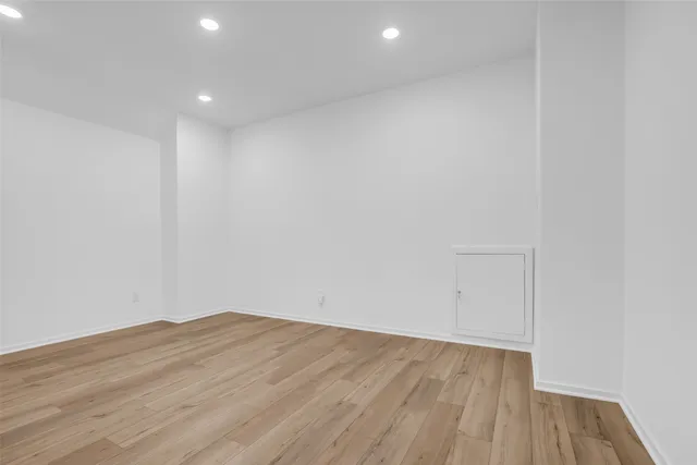 a bedroom with a bed and a potted plant