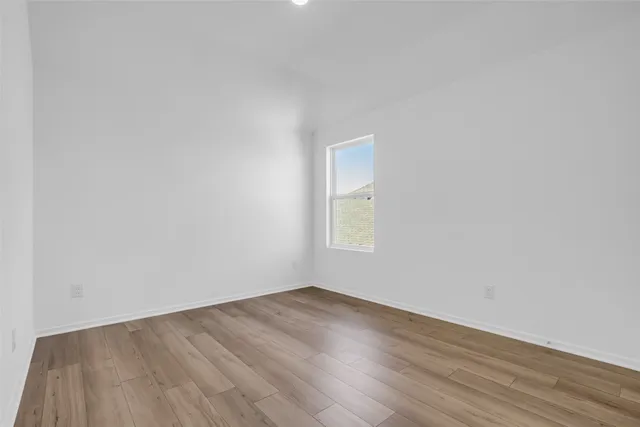 a bedroom with a bed and painting on the wall