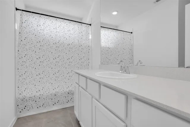 a bedroom with a bed a couch and dresser