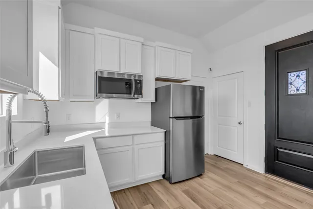 a kitchen with a refrigerator sink and microwave
