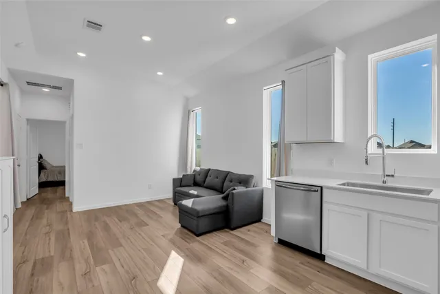 a kitchen with stainless steel appliances granite countertop a sink and a refrigerator