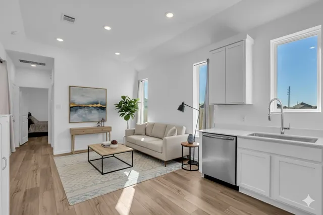 a living room with furniture and a wooden floor
