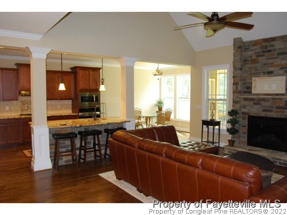 46 Spring Pond Lane Spring Lake, NC 28390 - Photo 3 of 12 a living room with furniture a fireplace and a dining table