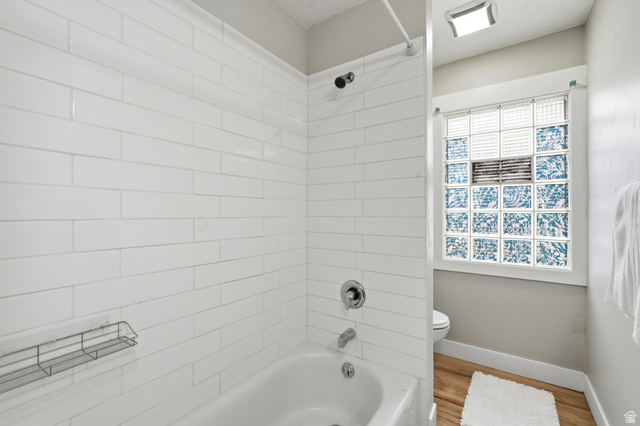778 East 200 North Logan, UT 84321 - Photo 31 of 43 Bathroom featuring a white subway tile surround, chrome fixtures, and a glass block window with patterned accents