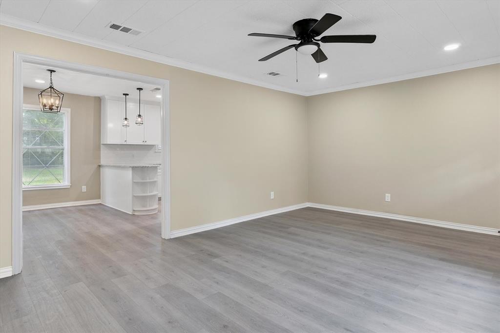 415 Maple Drive Terrell, TX 75160 - Photo 11 of 26 wooden floor in an empty room with a window