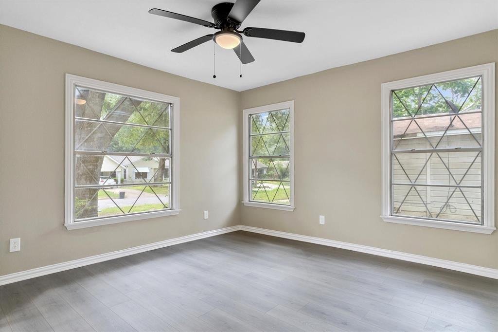 415 Maple Drive Terrell, TX 75160 - Photo 13 of 26 an empty room with windows and a ceiling fan