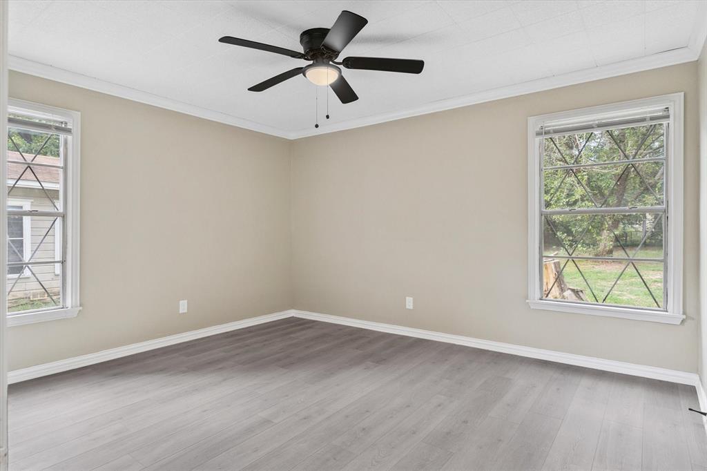 415 Maple Drive Terrell, TX 75160 - Photo 15 of 26 wooden floor in an empty room with a window
