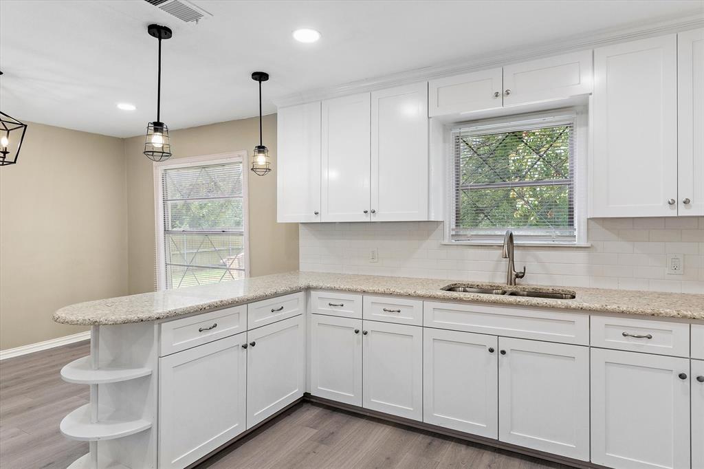 415 Maple Drive Terrell, TX 75160 - Photo 8 of 26 a kitchen with a sink window and cabinets