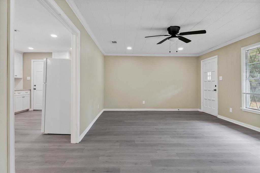 415 Maple Drive Terrell, TX 75160 - Photo 10 of 26 an empty room with wooden floor and windows
