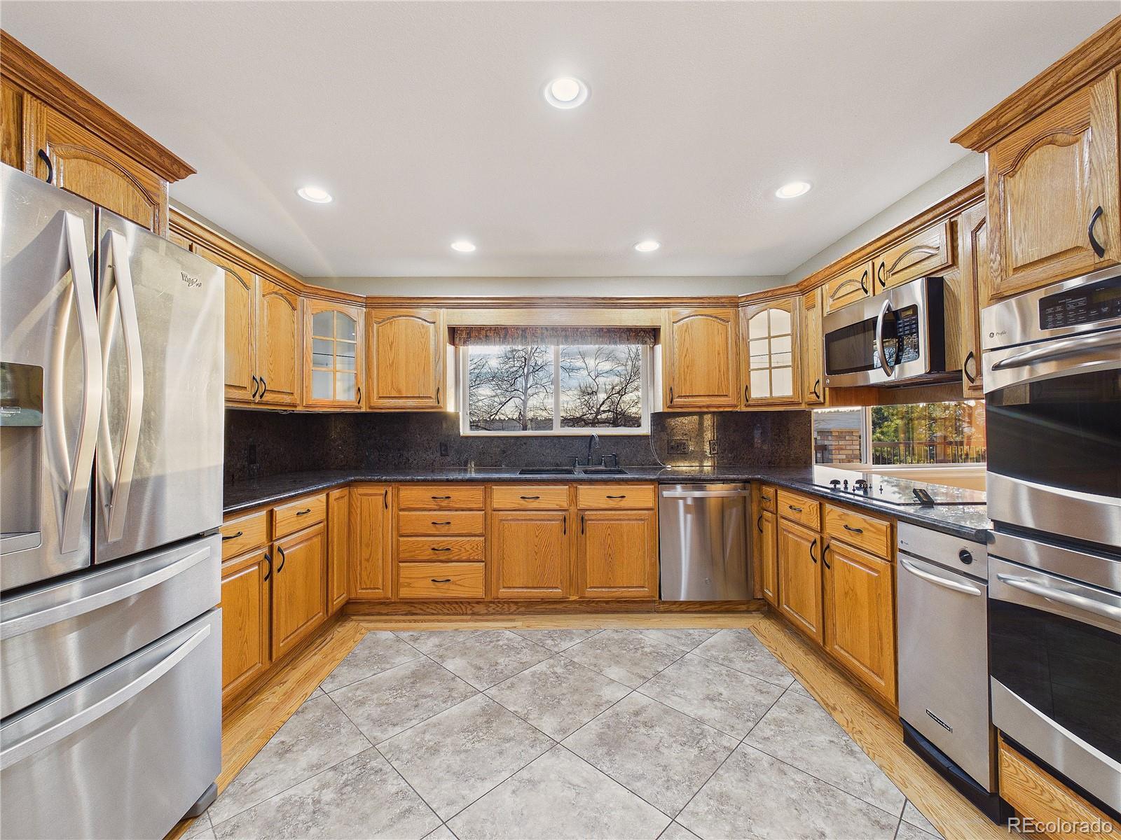 6423 Arrowhead Trail Elizabeth, CO 80107 - Photo 13 of 46 a large kitchen with stainless steel appliances granite countertop a refrigerator and a stove top oven