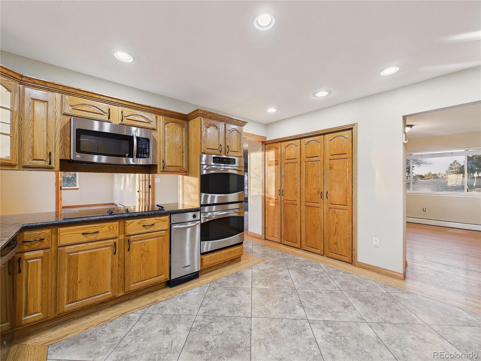 6423 Arrowhead Trail Elizabeth, CO 80107 - Photo 14 of 46 a kitchen with stainless steel appliances granite countertop a stove top oven a sink dishwasher a refrigerator and a microwave