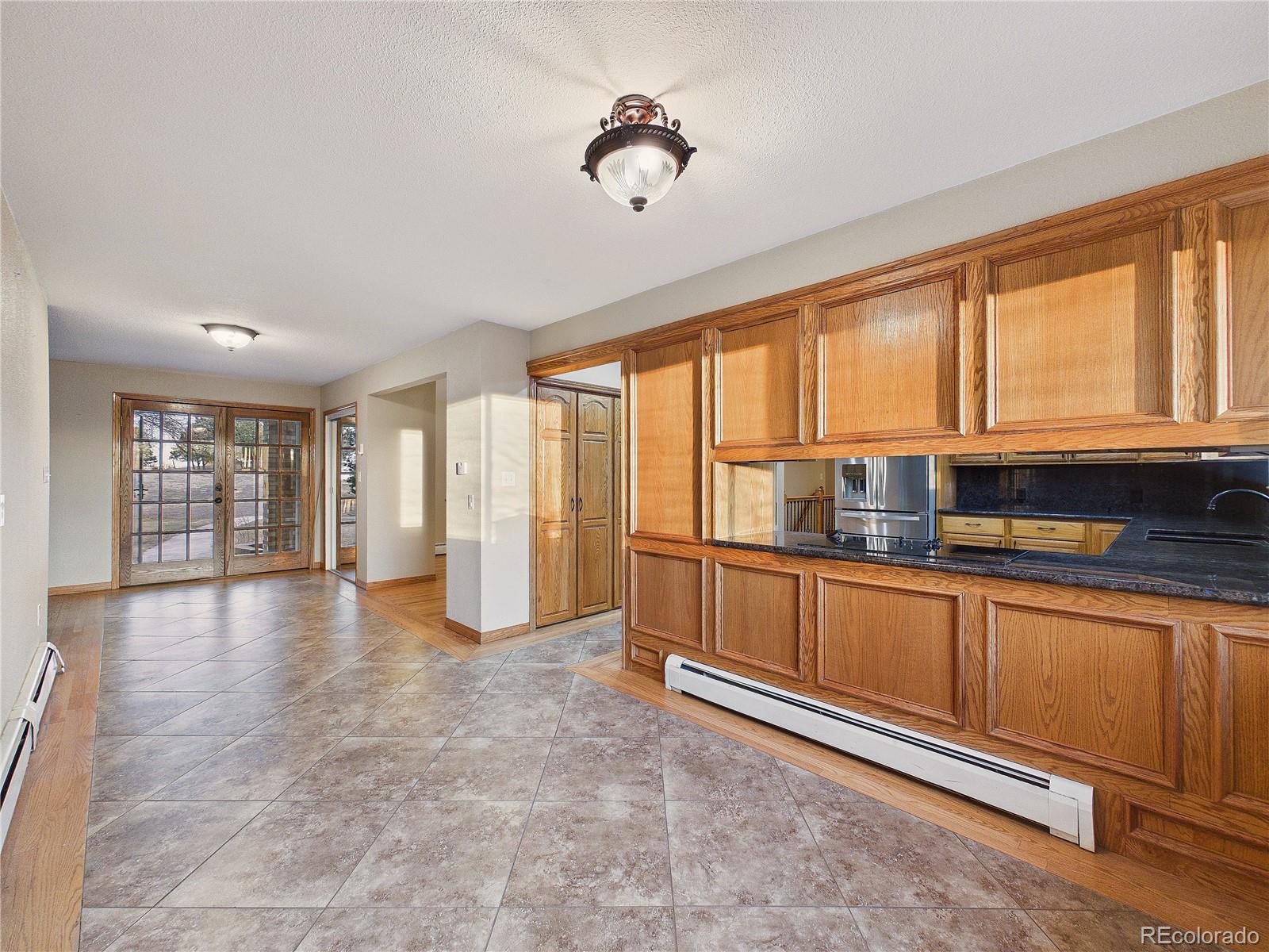 6423 Arrowhead Trail Elizabeth, CO 80107 - Photo 15 of 46 a view of a kitchen with granite countertop a sink and a refrigerator