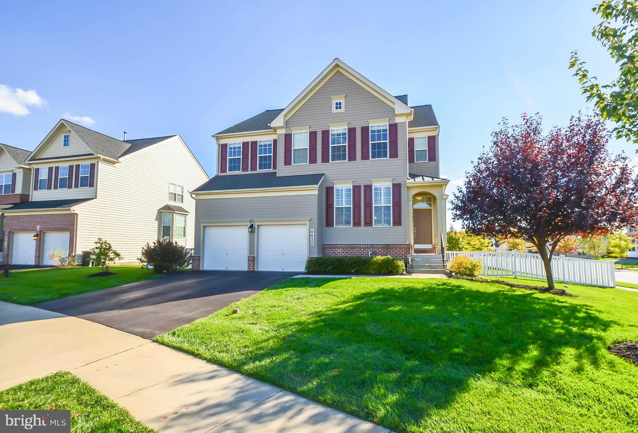 6620 Pebble Brooke Road Baltimore, MD 21209 - Photo 1 of 30 a front view of a house with a yard and garage
