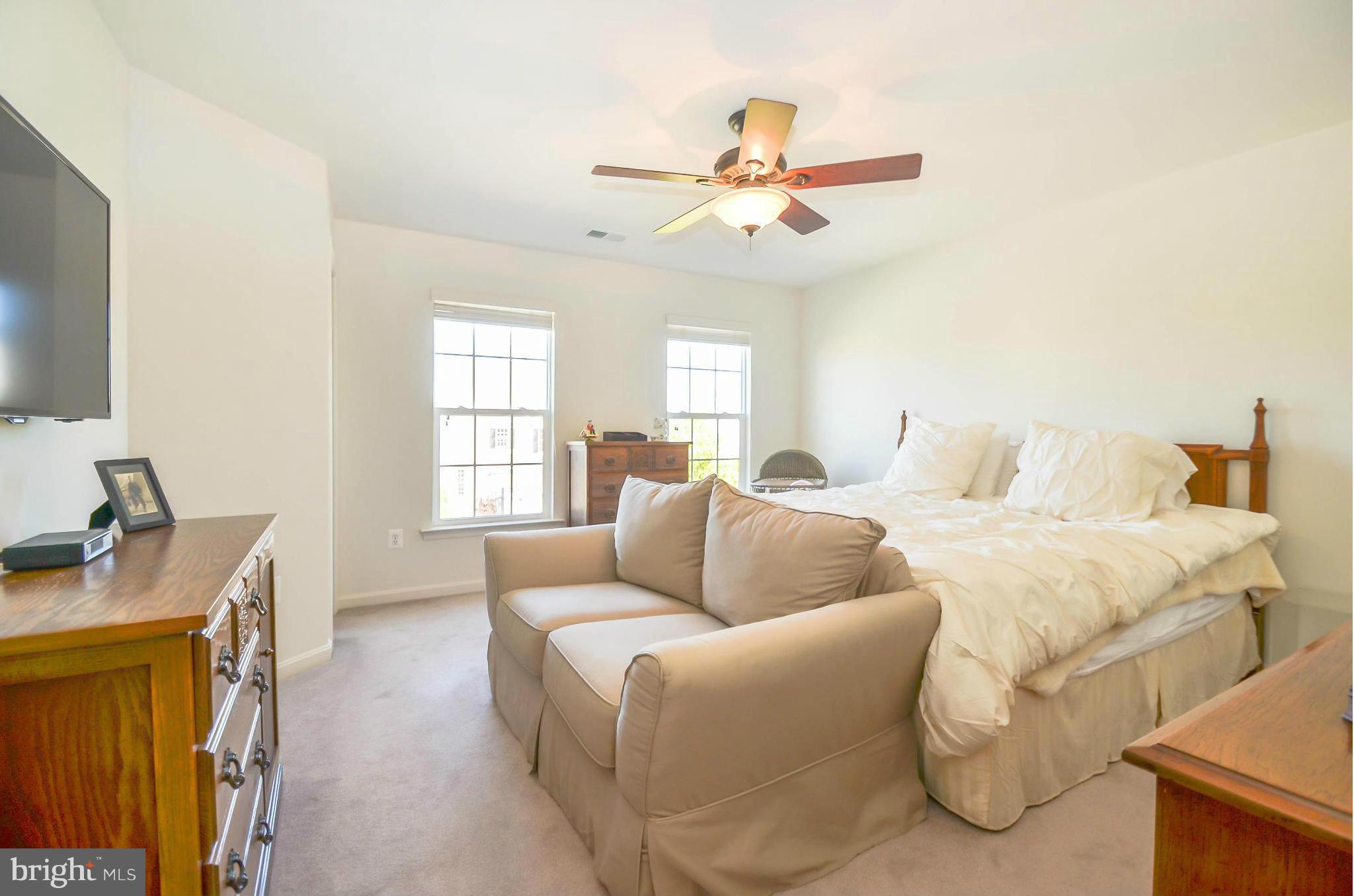 6620 Pebble Brooke Road Baltimore, MD 21209 - Photo 17 of 30 a bedroom with a bed and a chandelier