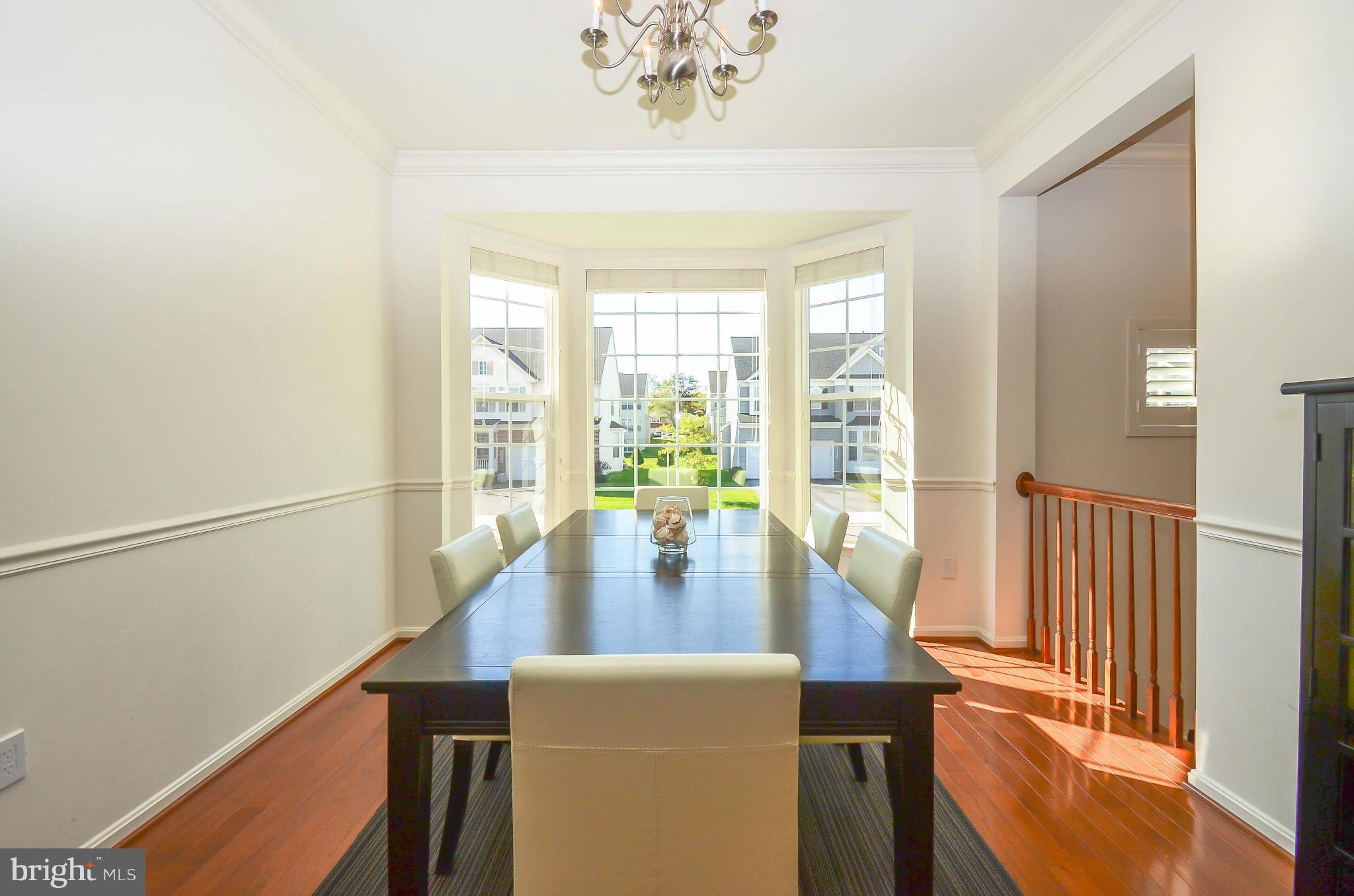 6620 Pebble Brooke Road Baltimore, MD 21209 - Photo 5 of 30 a dining room with furniture a chandelier and wooden floor
