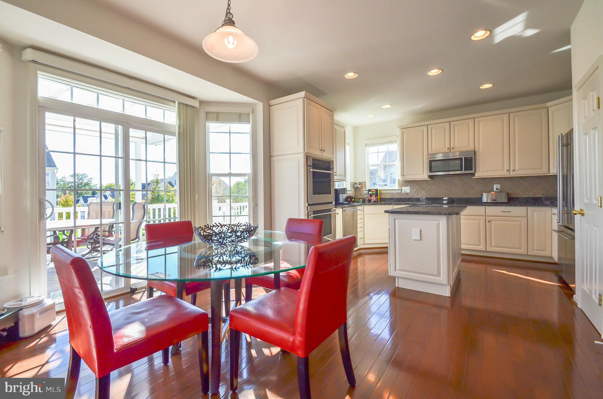 6620 Pebble Brooke Road Baltimore, MD 21209 - Photo 6 of 30 a view of a dining room with furniture wooden floor and a chandelier