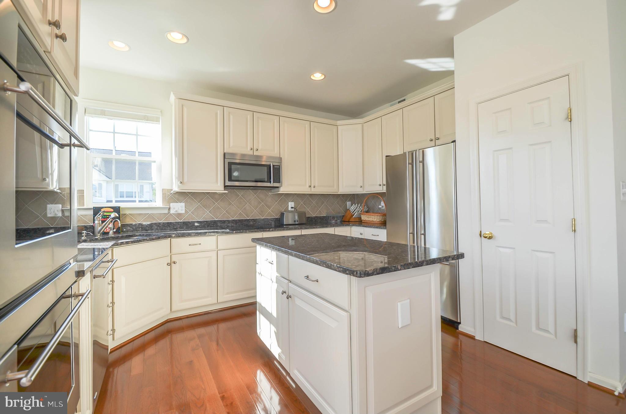 6620 Pebble Brooke Road Baltimore, MD 21209 - Photo 8 of 30 a kitchen with a white cabinets and refrigerator