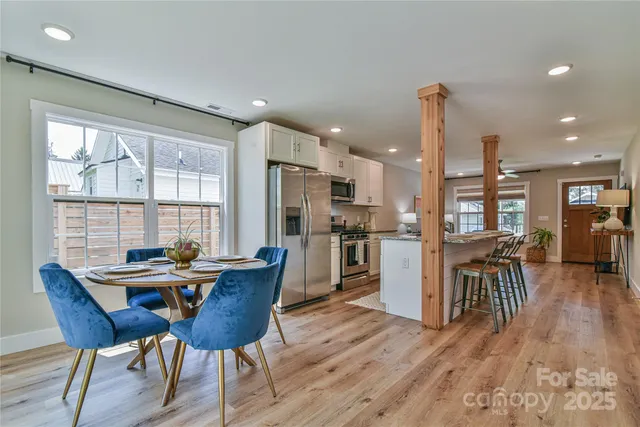 a dining room with furniture and wooden floor