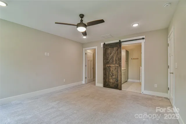 an empty room with closet and windows