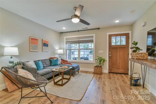 a living room with furniture and wooden floor