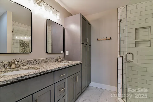 a bathroom with double sink and a mirror