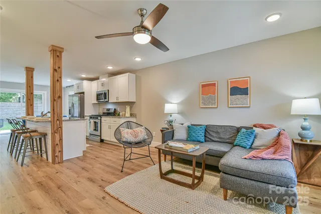 a living room with furniture and kitchen view