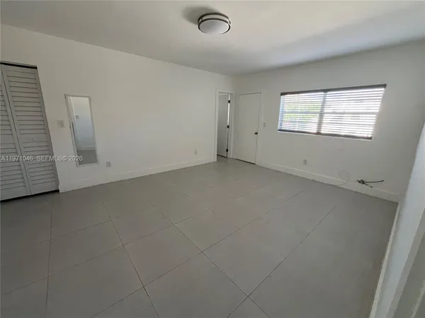 an empty room with a empty space and windows