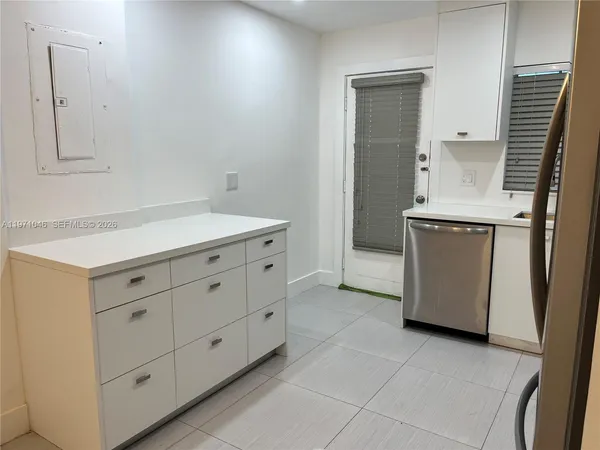 a kitchen with stainless steel appliances a refrigerator sink and microwave