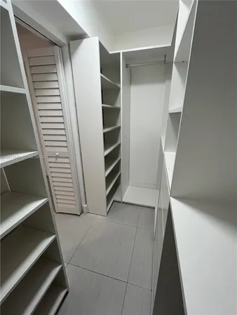 a view of an empty room and a window