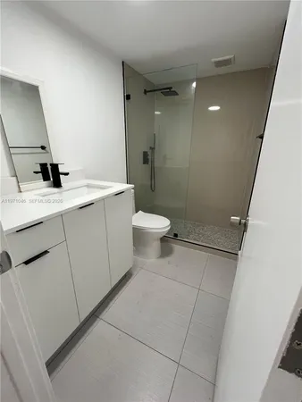 a kitchen with refrigerator and cabinets