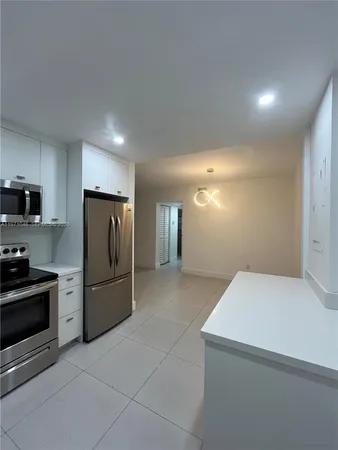 a kitchen with stainless steel appliances a refrigerator stove microwave and sink