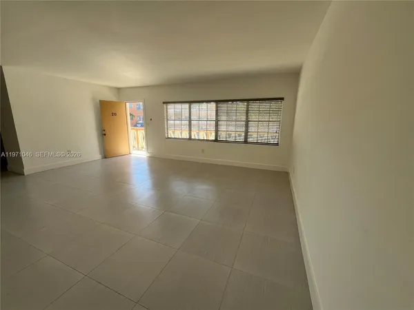 an empty room with windows and entrance