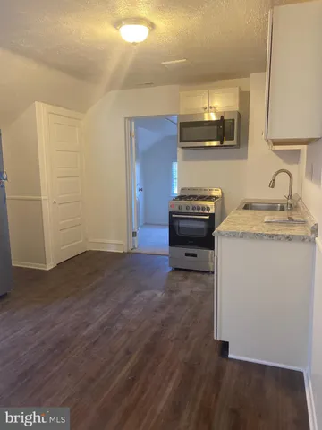 a view of kitchen and wooden floor