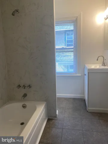 a bathroom with a bathtub and sink