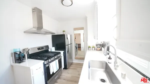 a kitchen with a sink stove and refrigerator