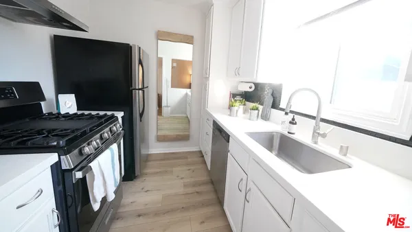 a kitchen with a sink stove and refrigerator