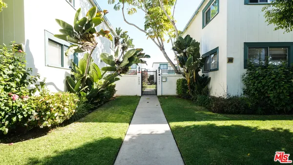 a view of yellow house with a yard