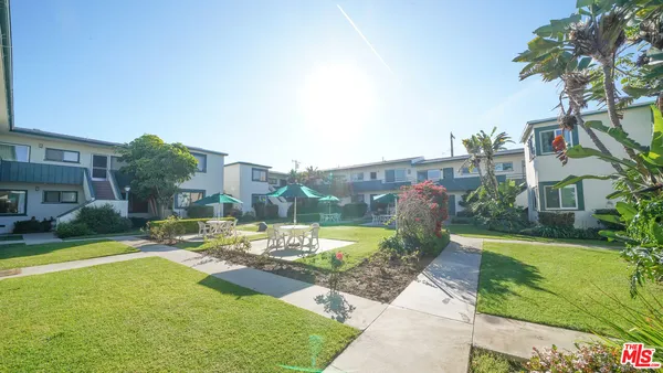 a view of a patio with swimming pool and a chairs