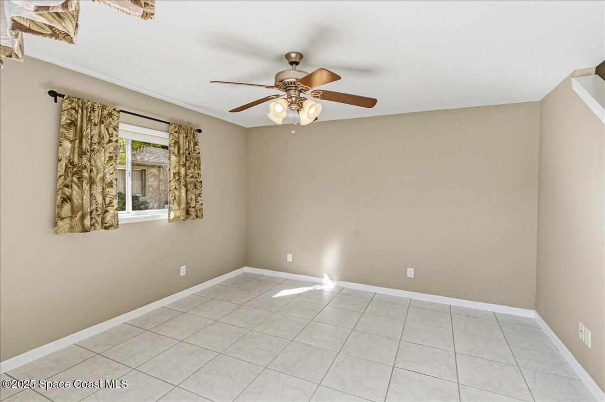 4129 Bond Avenue Rockledge, FL 32955 - Photo 12 of 45 a view of an empty room with a window and a fan