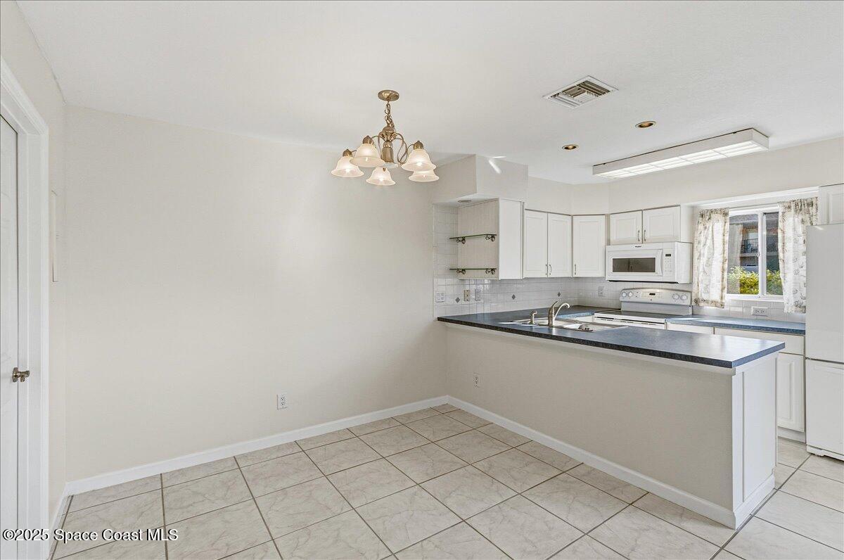 4129 Bond Avenue Rockledge, FL 32955 - Photo 13 of 45 a kitchen with granite countertop a sink and cabinets