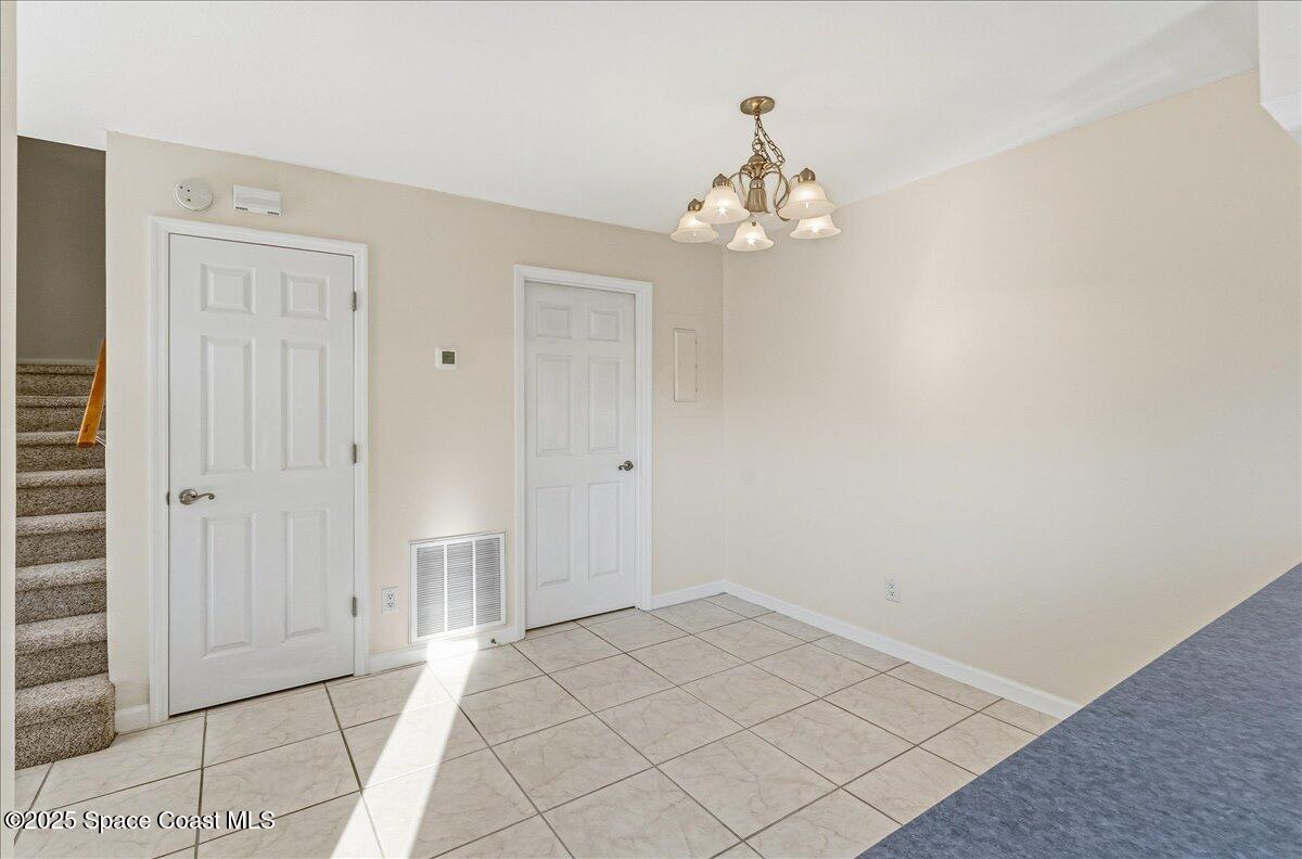 4129 Bond Avenue Rockledge, FL 32955 - Photo 14 of 45 a view of a chandelier fan and entryway
