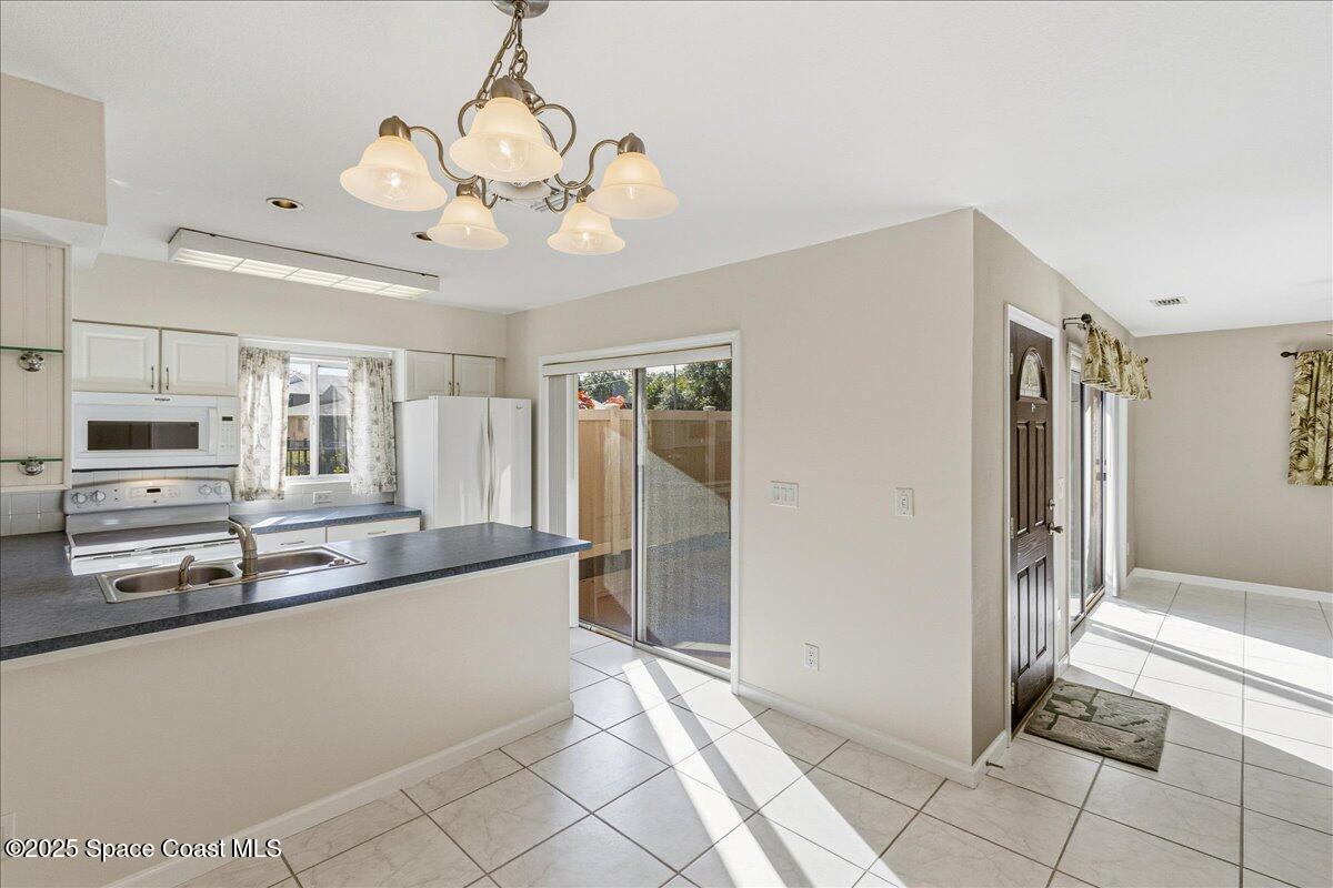 4129 Bond Avenue Rockledge, FL 32955 - Photo 16 of 45 a large kitchen with kitchen island granite countertop a refrigerator and a sink