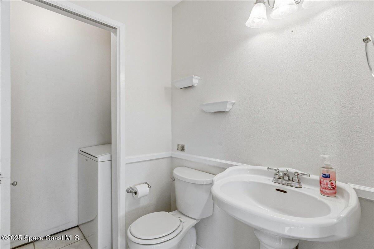 4129 Bond Avenue Rockledge, FL 32955 - Photo 18 of 45 a white toilet sitting next to a bathroom sink