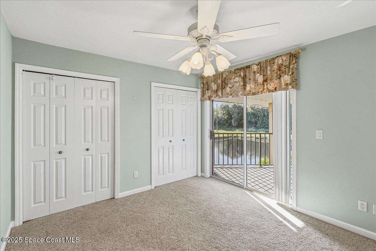 4129 Bond Avenue Rockledge, FL 32955 - Photo 21 of 45 an empty room with chandelier fan and windows